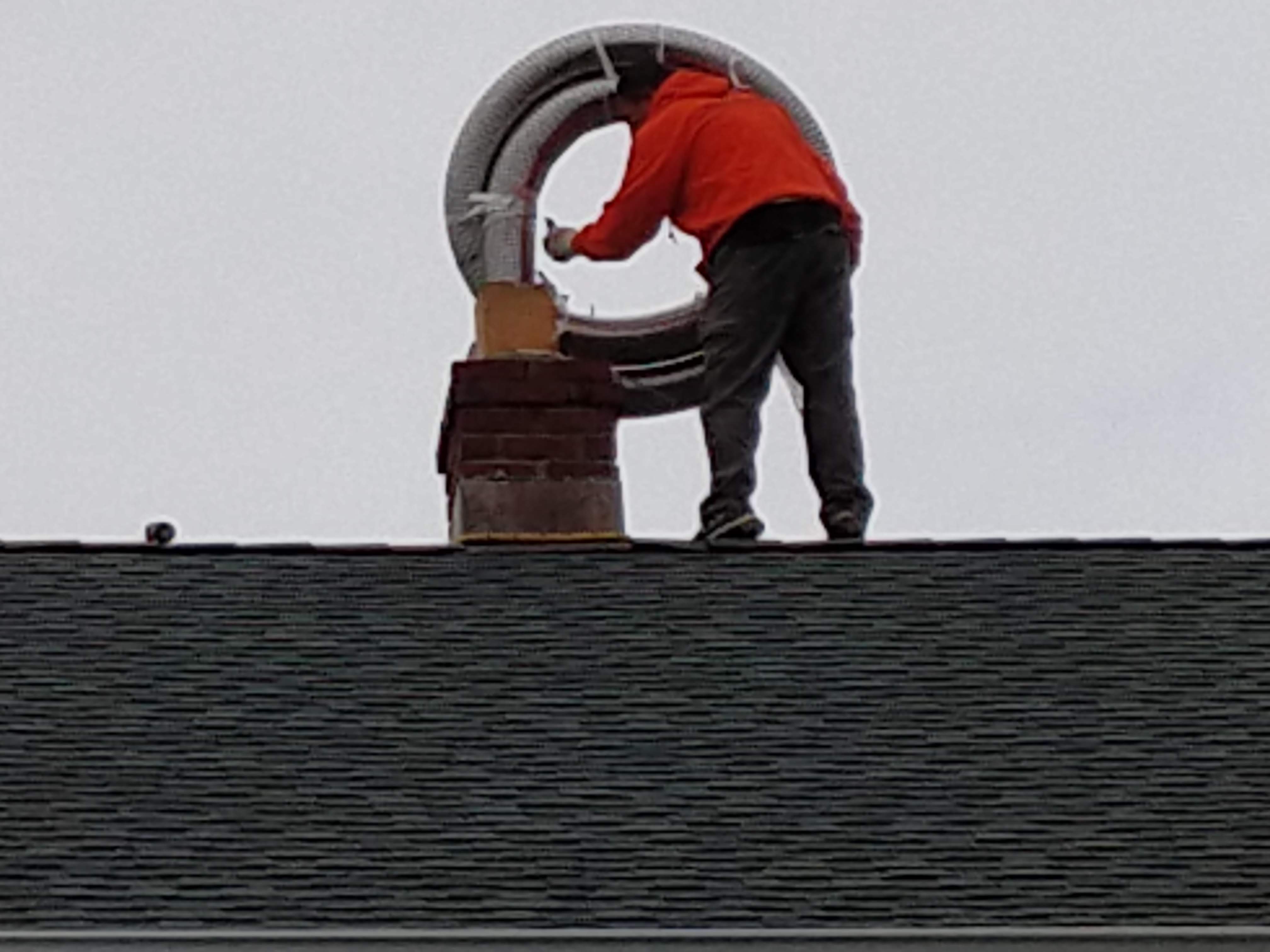 Flexible stainless chimney liner being installed in West Babylon, New York